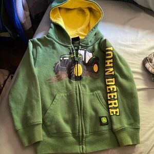 John Deere 4t green and yellow with a John Deere tractor on the front that zips